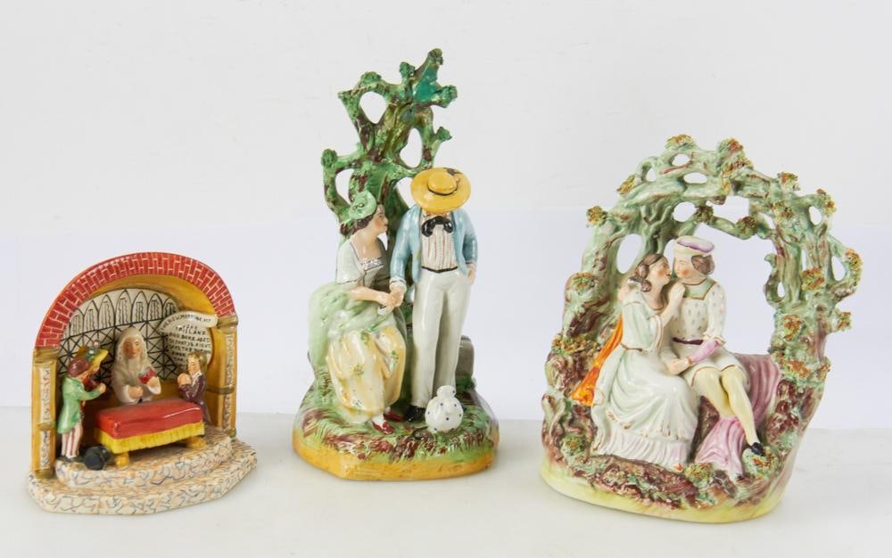 19thC Staffordshire Figures: Three (3) 19th century Staffordshire figures, to include seated couple titled "The New Marriage Act", young couple with background tree. Tallest 11 3/4". Tree has broken and been restored; otherwise,