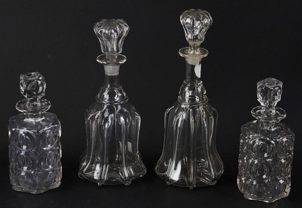 19thC Free-blown Wine Decanters, Mold-Blown Spirit Decanters: Pair of 19th century free-blown wine decanters with original stoppers, together with a pair of mold-blown spirit decanters. Tallest 11 3/4". Good condition. Provenance: Estate of Dalia Zikas, Melrose,