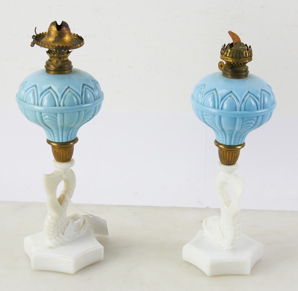 Pair of 19thC Opaque Blue and White Oil Lamps: Pair of 19th century opaque blue and white oil lamps, dolphin base, 13 1/4". Good condition. Provenance: Estate of Dalia Zikas, Melrose, Massachusetts.