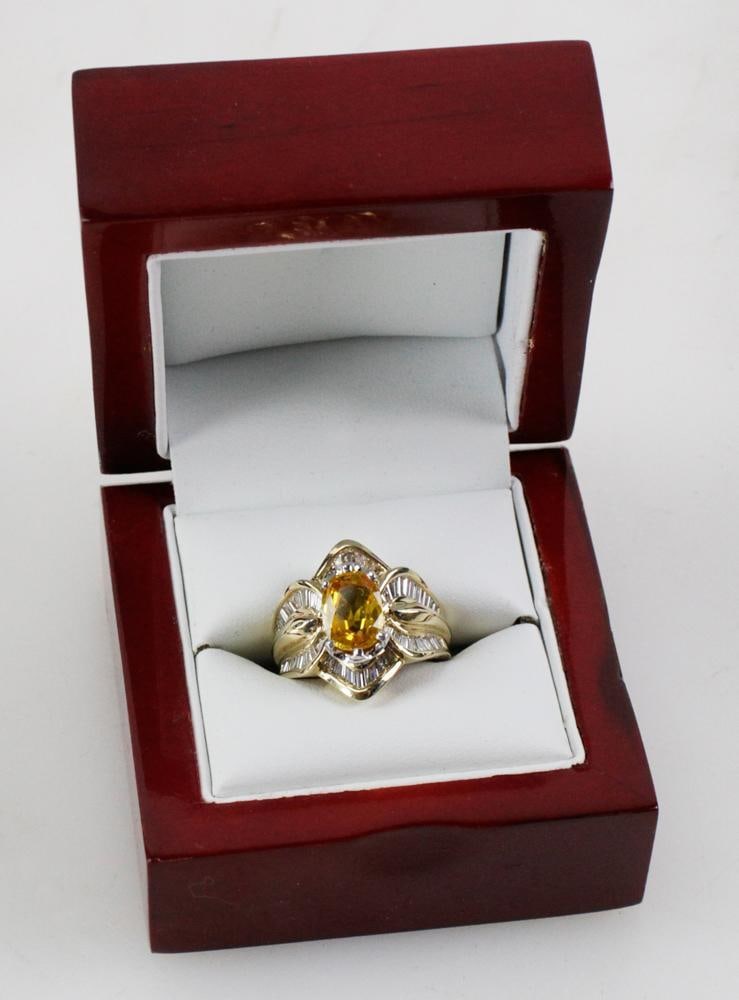 14k Yellow Gold, Yellow Sapphire and Diamond Ring: Yellow sapphire and diamond ring in 14k yellow gold. Yellow sapphire 7.09 x 9.68 x 4.43mm, approximately 3.10 cts; (62) baguette diamonds, approximately 1.51 ctw, F color, VVS/VS clarity. Gross weight