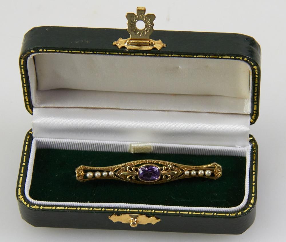 14k Gold, Amethyst, and Seed Pearl Bar Pin: 14k gold, amethyst, and seed pearl bar pin. 2 1/4" L. Approximately 4.45 grams TW. Provenance: Miami Beach, Florida collection. PLEASE NOTE: payment for silver, gold, jewelry, and coins must be made