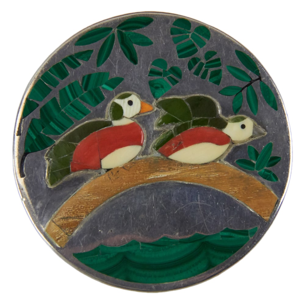 Sterling Pendant Pin with Birds, Signed Blue Moon: Sterling pendant pin with birds, comprising British Columbian jade, Mississippi River mother-of-pearl, Philippine Islands shell, and Alaskan mastodon bone. Signed JS with arrow and crescents, and