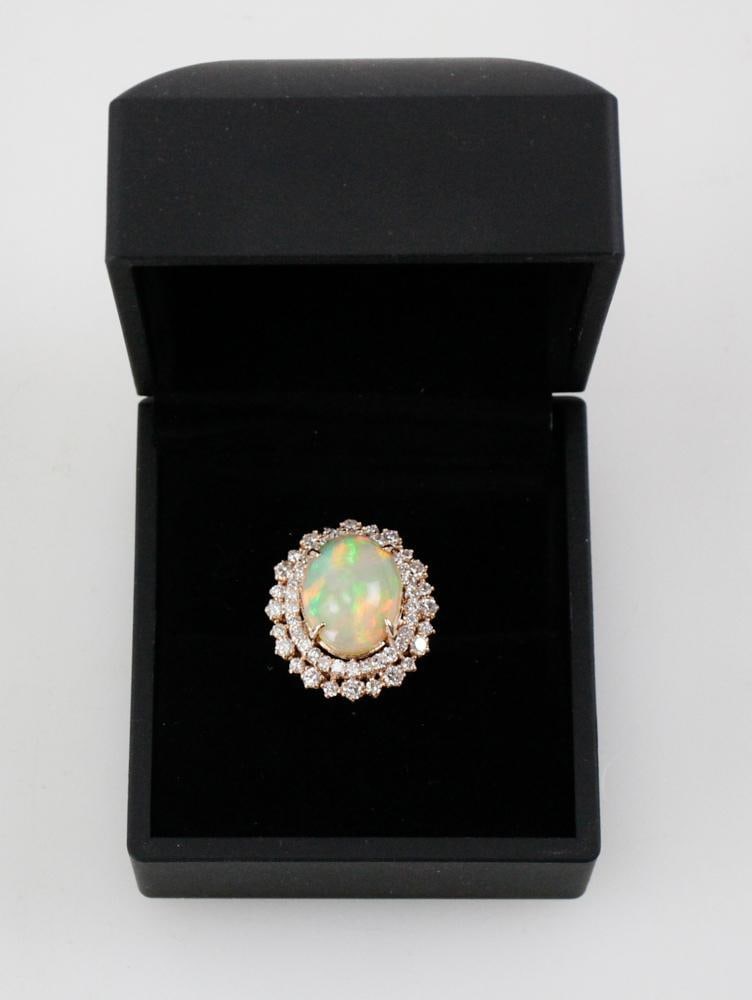 14k Pink Gold, African Opal and Diamond Ring: African opal and diamond ring in 14k pink gold. Oval African opal 12.8 x 16 x 11mm D, approximately 12 cts; (54) round brilliant cut diamonds, approximately 2.0 ctw, G-H color, VS clarity. Gross