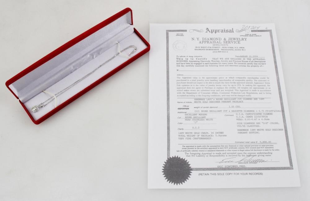 14k White Gold Diamond Pendant Necklace: Diamond pendant in 14k white gold setting on 14k white gold chain 16" L. Center diamond 6.65-6.67 x 3.93mm, approximately 1.05 cts, J,K color, SI clarity. (10) round brilliant cut and (2) baguette