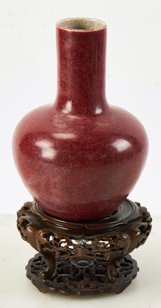 18th/19thC Chinese Ox-Blood Vase on Wood Stand: 18th/19th century Chinese sang-de-boeuf ox-blood vase, 8" x 5 1/2. With wood stand. Small wood loss. Provenance: Hollywood, Florida collection.