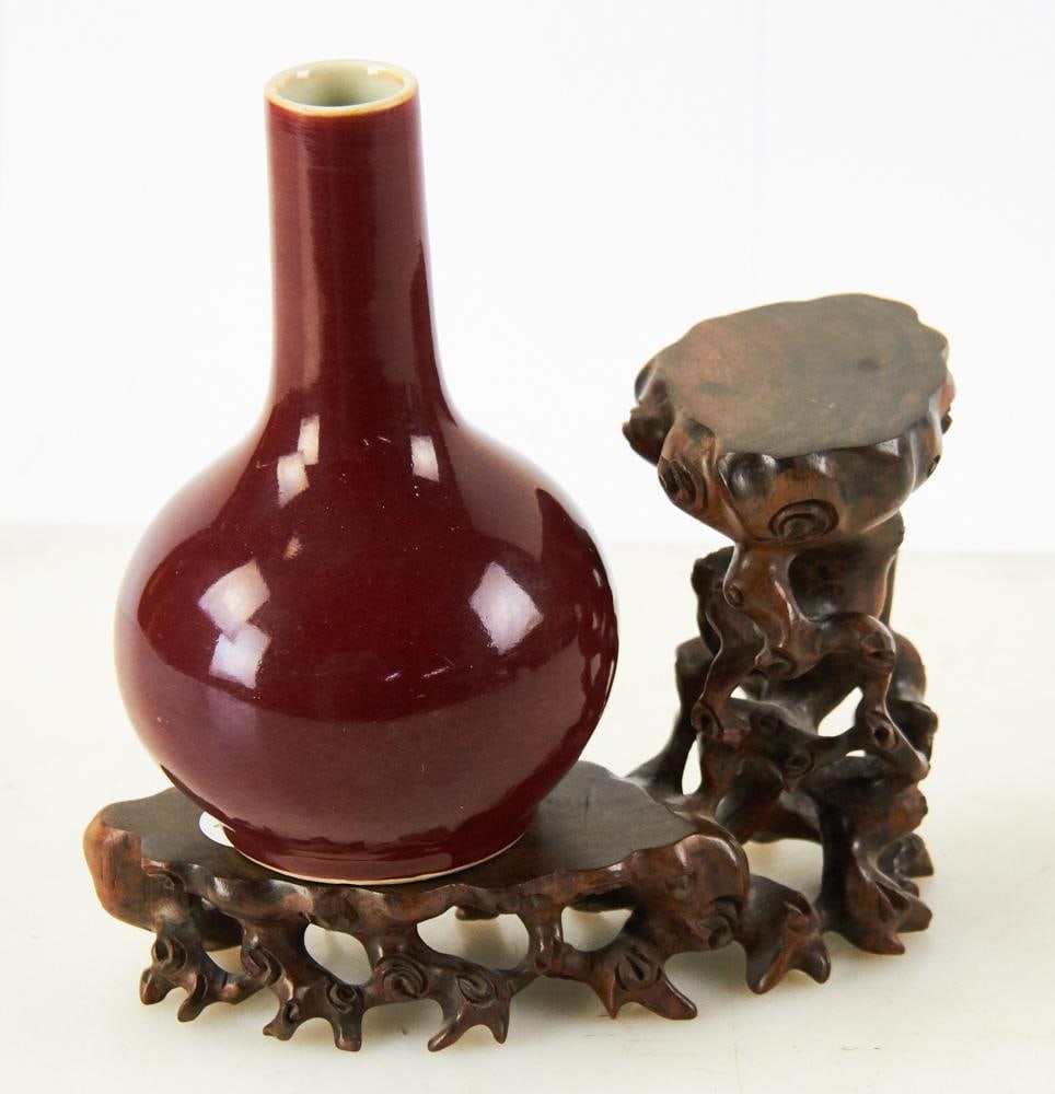 18th/19thC Chinese Ox-Blood Vase on Wood Stand: 18th/19th century Chinese sang-de-boeuf ox-blood vase, vase, 6 1/2" x 4", on wood stand 5" x 7 1/2". Provenance: Hollywood, Florida collection.