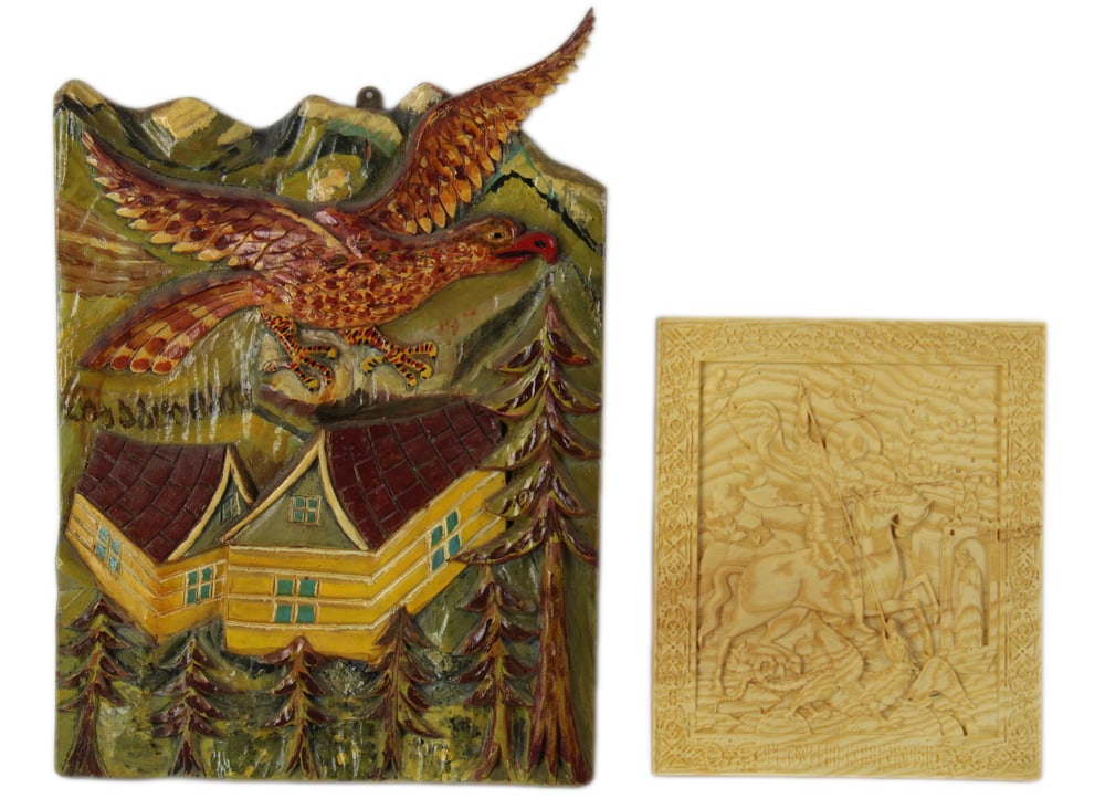 Plaques of Saint George Slaying Dragon, and Eagle: Two plaques, including: carved wood plaque of Saint George slaying the dragon, 10" x 8"; Folk Art carved and painted plaque of eagle over houses, 16 1/2" H x 11 1/2" W. Both in good condition.