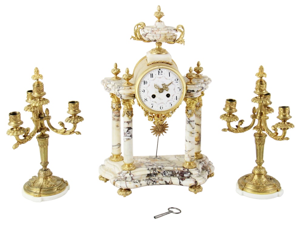 19thC French Louis XVI 3-piece Pillared Clock Set: 19th century French Louis XVI style pillared clock set, white marble with black veins, clock having urn top, 19" H x 13" W x 6" D, with pair of column three-light candelabra with white marble round ba