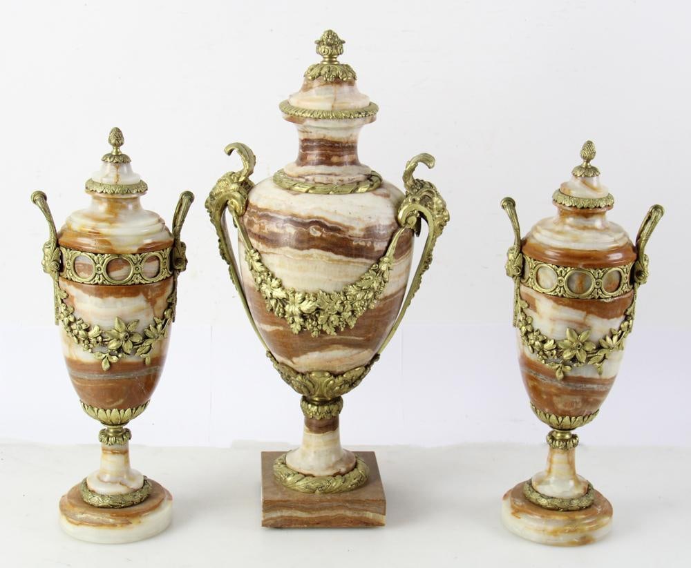 19thC Neoclassical-Style 4-Piece Clock Set: 19th century Neoclassical style 4-piece clock set, comprising: white and brown onyx clock, base with gilt solid bronze male classical figure, base 7" H x 14" W x 10" D, figure 18" H x 7 1/2" W x 6" D;