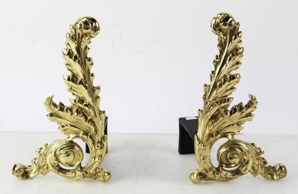 Pair of 20thC French Brass Chenets: Pair of 20th century French brass chenets, feather upright with curled bottom design, 15" H x 11" W x 6 1/2" D. Provenance: From the 50-year personal collection of Mr. John Hvozda of Hermitage,