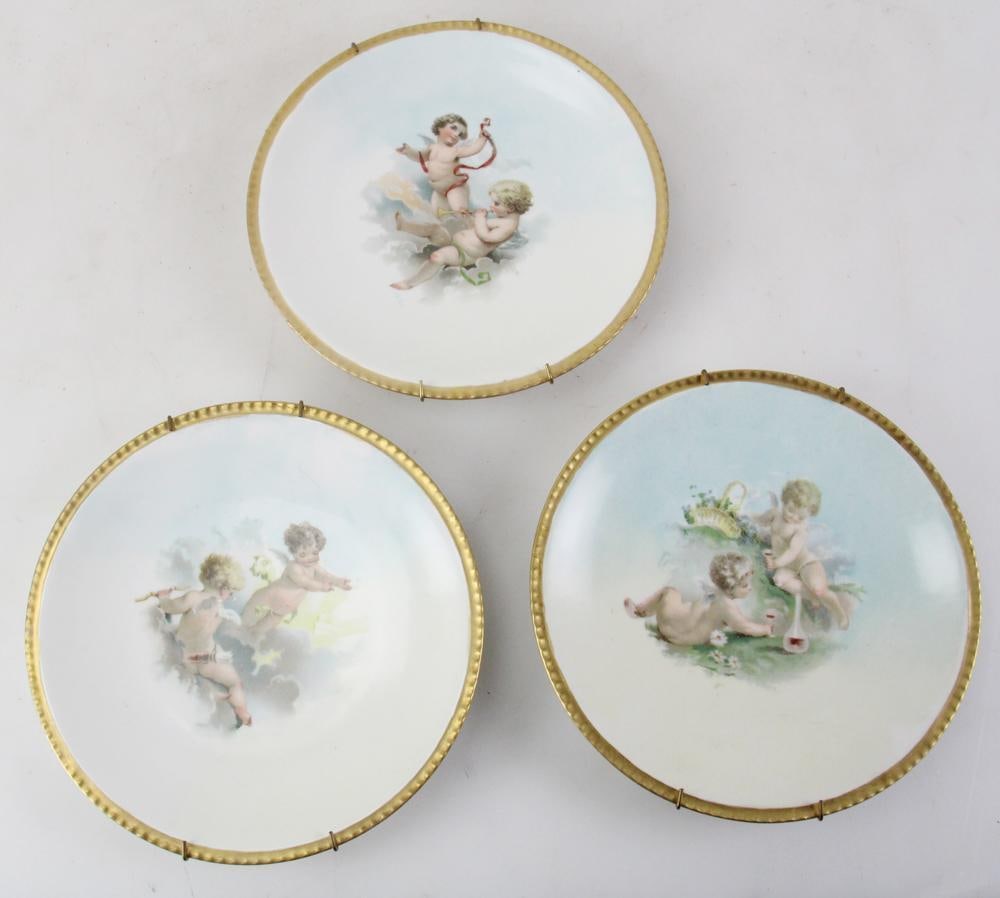 Set of 19thC Limoges Finely Hand-Painted Plates: Set of three 19th century Limoges plates with finely hand-painted pastel cherub scenes with clouds, 8" diameter. With hanging wires. Provenance: From the 50-year personal collection of Mr. John
