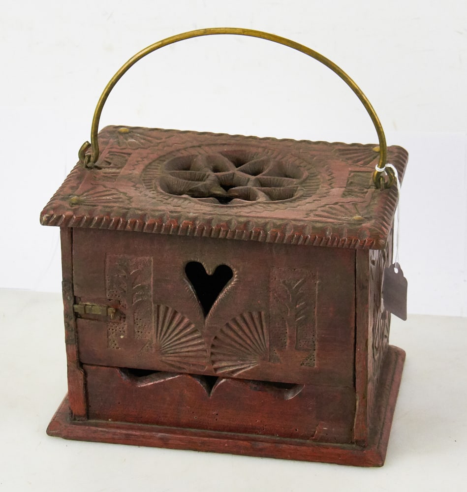 Antique Dutch Chip-Carved Foot Warmer: Antique Dutch chip-carved foot warmer with brass handle, 7 1/4" H x 9 1/2" x 7". Traces of original red paint. Crack on one side of top; otherwise, good condition. Provenance: Estate of Dalia Zikas