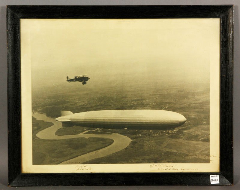 Photograph of Zeppelin and WWI Prop Plane: Photograph of a Zeppelin and WWI propeller plane, inscribed "LBE Gates C.O. 5th Squadron, kindest regards to the 26th", signature is illegible, 26"h x 21 1/2"w (frame).