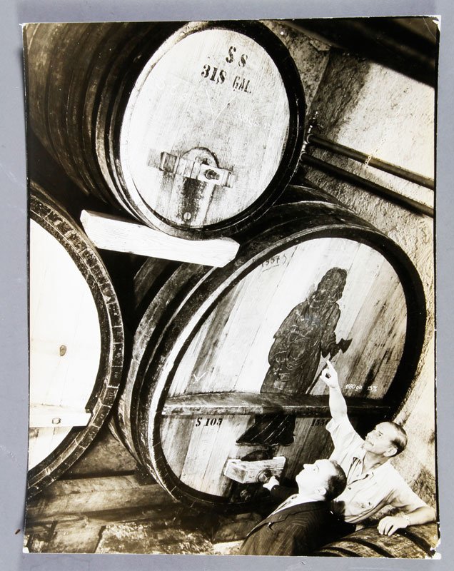 Bourke-White, Men in Wine Cellar, Gelatin Silver Print: Margaret Bourke-White, two men in a wine cellar, gelatin silver print, stamped on reverse, unframed, 10 6/8" x 14 1/2"w. Creases to corners.
