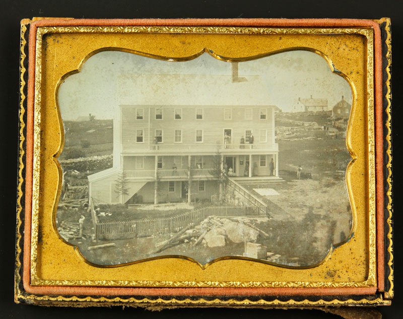 Daguerreotype of Outdoor Scene: Quarter Plate Daguerreotype of outdoor scene of a hotel with about thirteen people standing outside, note the tall gentleman with stove top hat on first floor landing, there are three houses in the ba