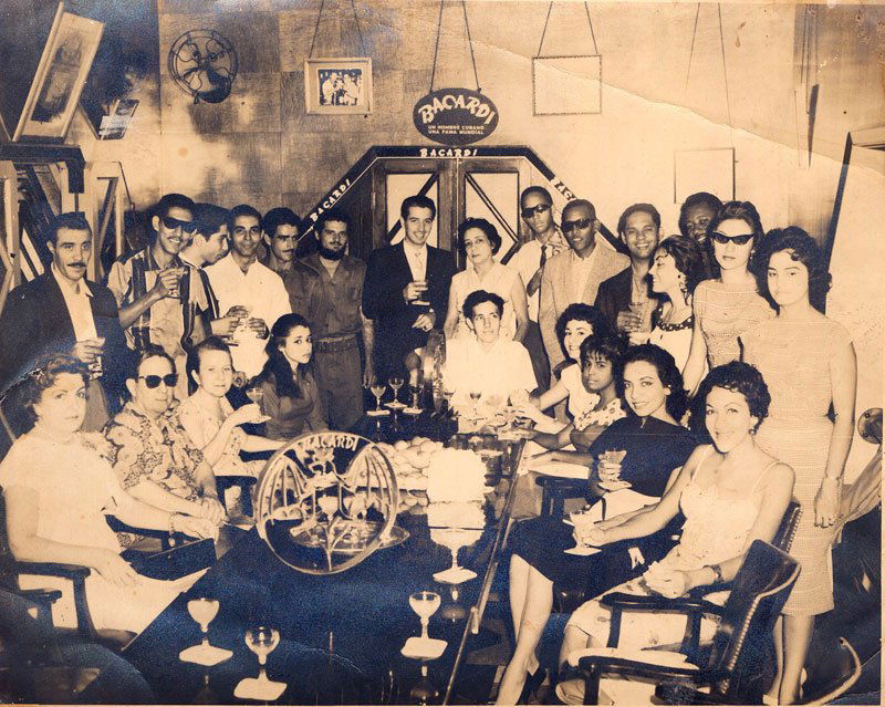 Photograph of Last Party at Bacardi Building: Photograph of last party at Bacardi Building before Communists intervened, includes: Argentina Estevez with body guards and friends, Bacardi Company representatives, dated verso "1959", 8"h x 10"w. Or