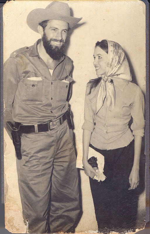 Photograph of Cienfuegos and Estevez: Photograph of Comandante Camilo Cienfuegos, second in command under Fidel Castro during the Revolution of Cuba, with girlfriend and lover Argentina Estevez , inscribed verso "Foto Rafael Gonzalez", "P