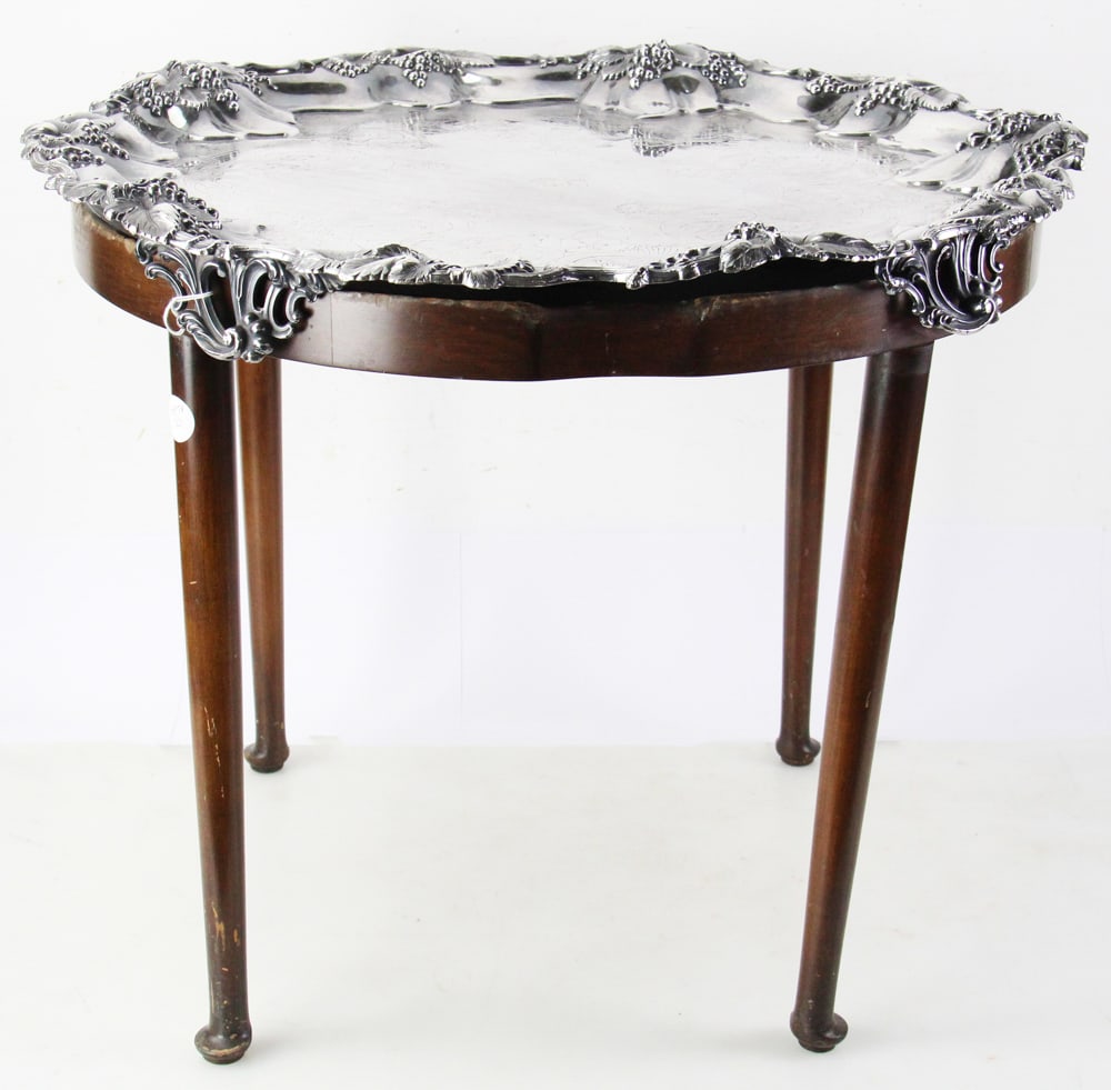 Silverplate Serving Tray on Mahogany Stand: Silverplate serving tray on mahogany stand, tray 24 1/2" diameter; stand 19 1/2" H x 22 1/2" diameter. Provenance: Estate of Thomas Nicholson of Palm Beach, Florida and Stratham, New Hampshire. PLEASE