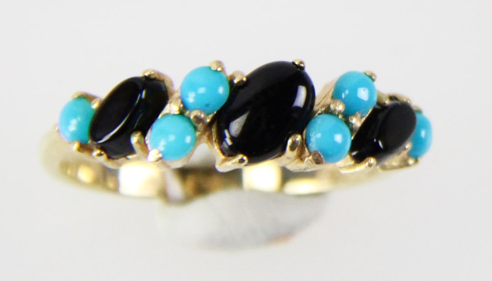 14k Gold Onyx and Tanzanite Ring: 14k gold ring with (3) oval onyx stones and (6) oval tanzanite stones, size 6 1/2. Approximately 2.27 grams TW with stones. Provenance: Miami Beach, Florida collection. PLEASE NOTE: payment for silver