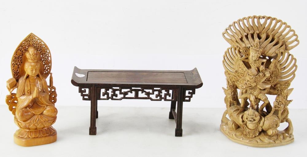 Balinese Vishnu on Garuda, Guanyin Statue, Wood Stand: Balinese wood carving depicting the Hindu deity Vishnu on his mount, the creature Garuda, 12" x 7"; hand-carved wood Guanyin Bodhisattva statue with lotus base, 10" x 4"; wood stand, 5" x 12".