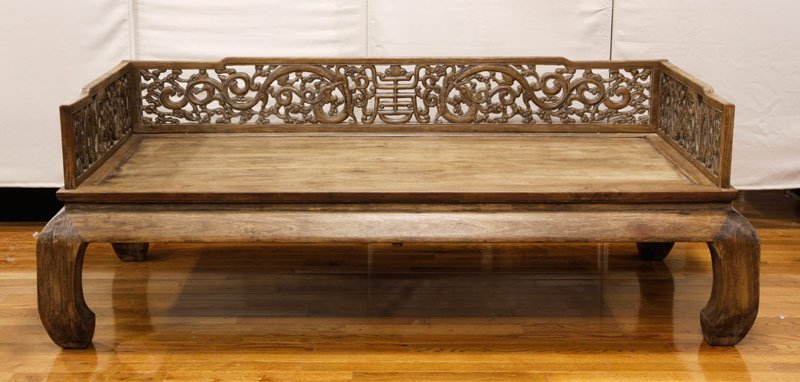 Chinese Large Huanghuali Bed: Large Huanghuali wood bed, China, Qing Dynasty, the side panels decorated with scrolling dragons and clouds, on short curvilinear legs, 29 1/2" h x 80" l x 43" d.