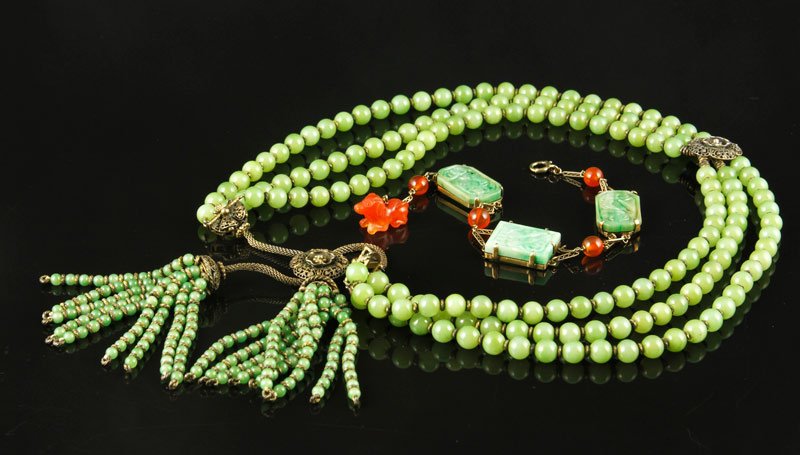 Chinese Jade Beaded Necklace and 14 K Gold and Jade: 14 K yellow gold bracelet, China, with flat carved jade pieces and coral ornaments, 8 1/2" l and a three stranded jade beaded necklace with tassel detail, China, 19th century with gilt sterling silver