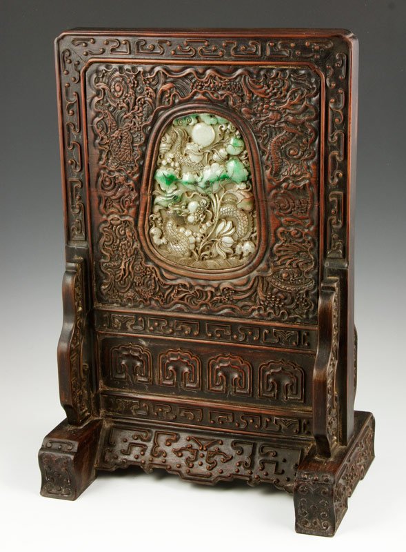 Chinese Zitan and Jadeite Table Screen: Zitan wood table screen, China, with mounted jadeite, carved in the form of a lotus plant with a dragon curled around it, and a carved dragon framing it, 18" x 11 1/2".