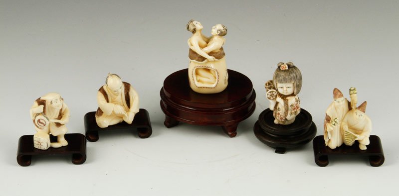 Japanese Carved Ivory Netsukes: Five carved netsukes, Japan, early 20th century, ivory, four signed, with five wood bases of assorted sizes, largest netsuke 2" h.