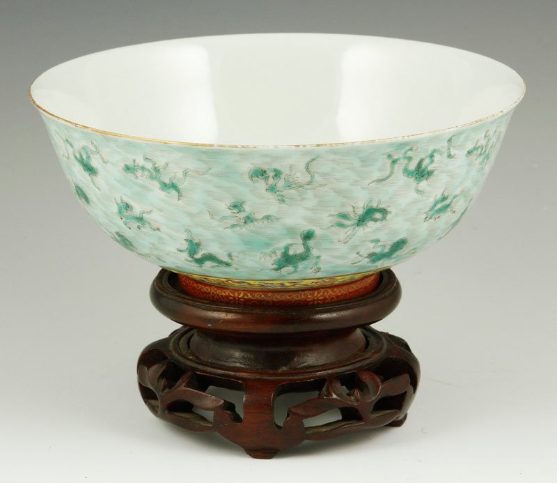 Chinese Famille Rose Bowl: Famille rose bowl, China, 18th/19th century, decorated with flying dragons, Qianlong mark on base, on hardwood stand, 2 3/4" x 6 5/8".