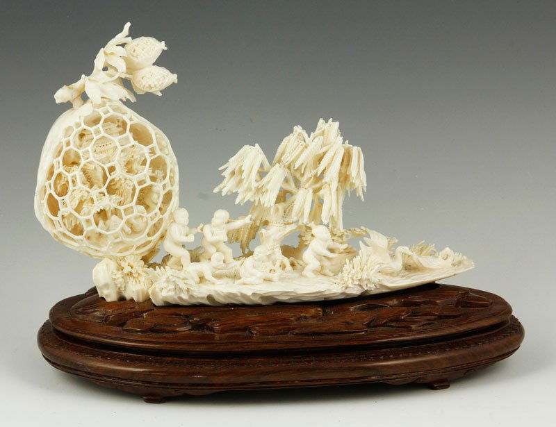 Chinese Carved Ivory Mythical Scene: Intricately carved ivory scene, China, depicting several figures and a pomegranate, 6 1/2" h x 9 1/2" w.