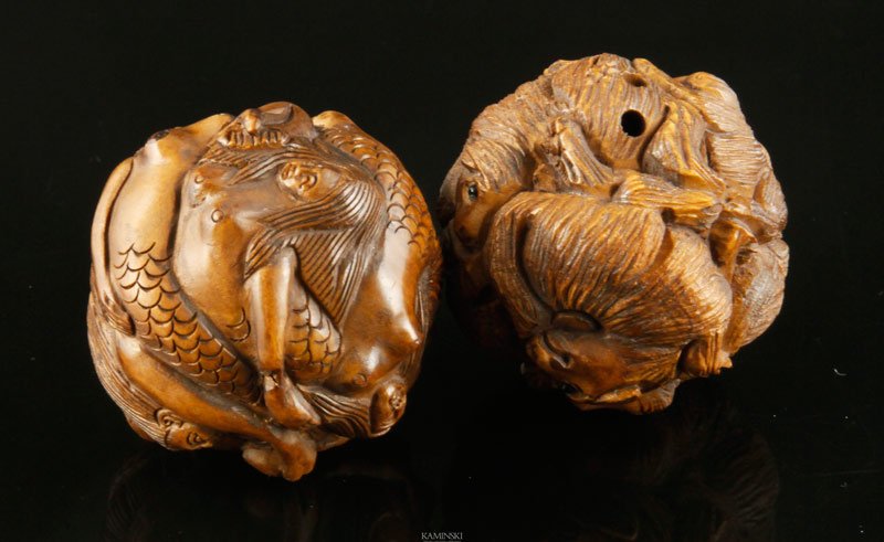 Japanese Carved Netsuke: Two carved boxwood netsuke, Japan, ball shaped, one carved with mermaids, one carved with dogs, 1 3/8".