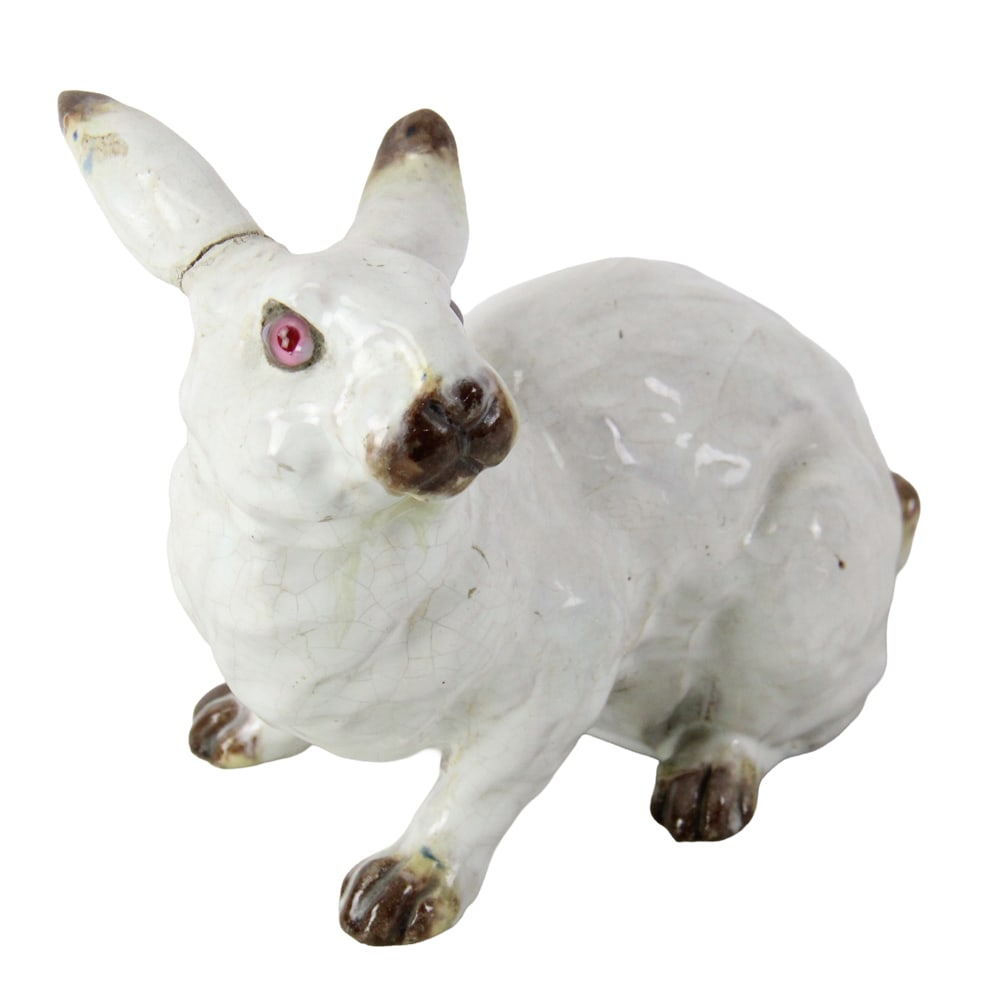 French Glazed Pottery Rabbit with Glass Eyes: French glazed pottery rabbit with glass eyes, 6 1/2 x 9. With repaired ear. Provenance: Estate of Joseph and Anna Prince Haley, of Pride's Crossing, Massachusetts.