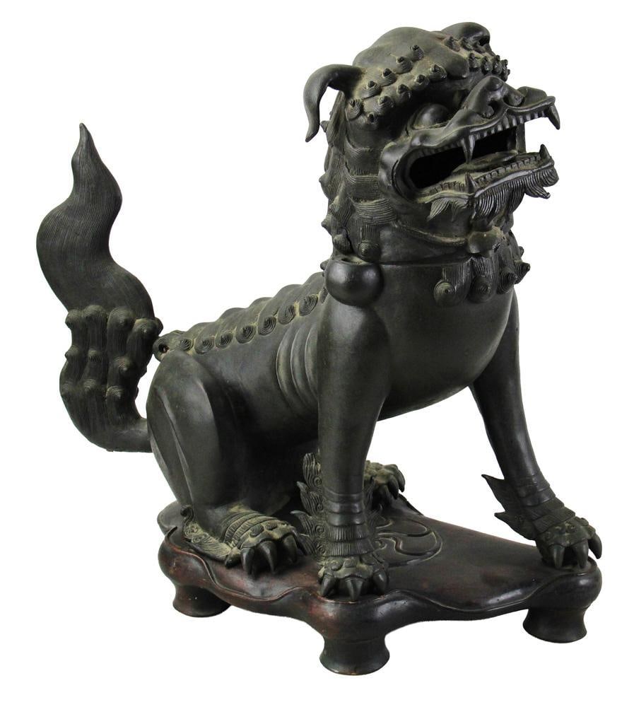 18th/19thC Chinese Bronze Foo Dog on Wood Stand: 18th/19th century Chinese bronze foo dog on wood stand, 23" x 24" x 9". Provenance: Estate of the late Joseph W. Haley, of Pride's Crossing, Massachusetts.