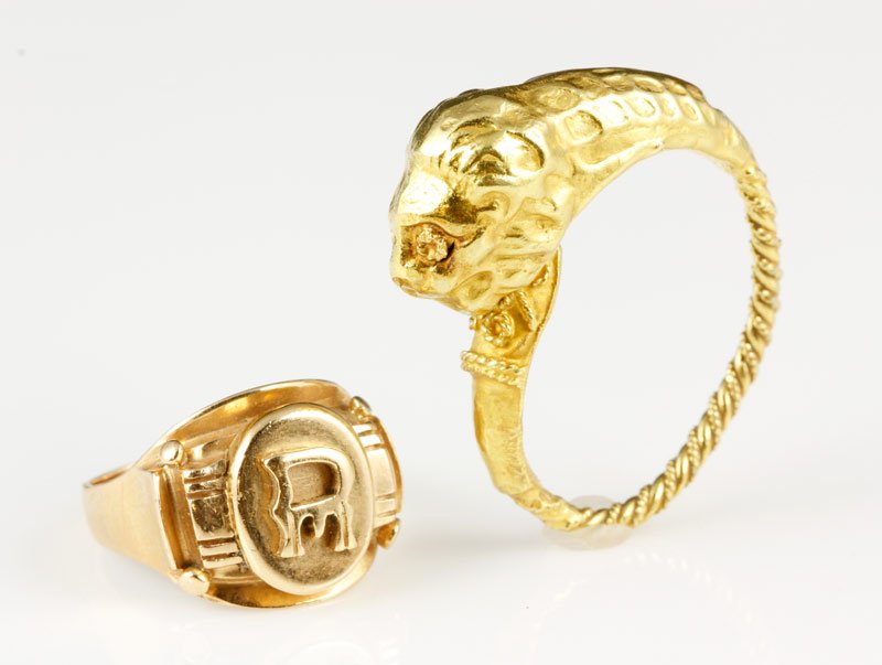 Lot of 2 Gold Rings: Lot of 2 gold rings including one 14K yellow gold with an "R", size 5 1/4, approximatelyimately .2oz TW, and one 18K yellow gold snake ring, approximately. .2 oz/ 3 DWT TW. Bent. From the collection o