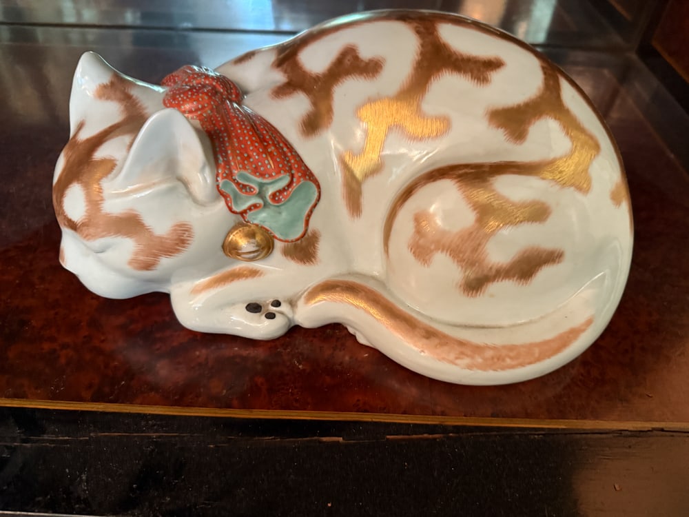 Japanese Porcelain Cat: Japanese porcelain cat, 6 1/2" H x 12" W. NOTE: Item to be picked up at 64 East 80th St., New York, NY. Deadline for pick-up is July 31st. Please call our front desk at 978-927-2223 to schedule pick-u