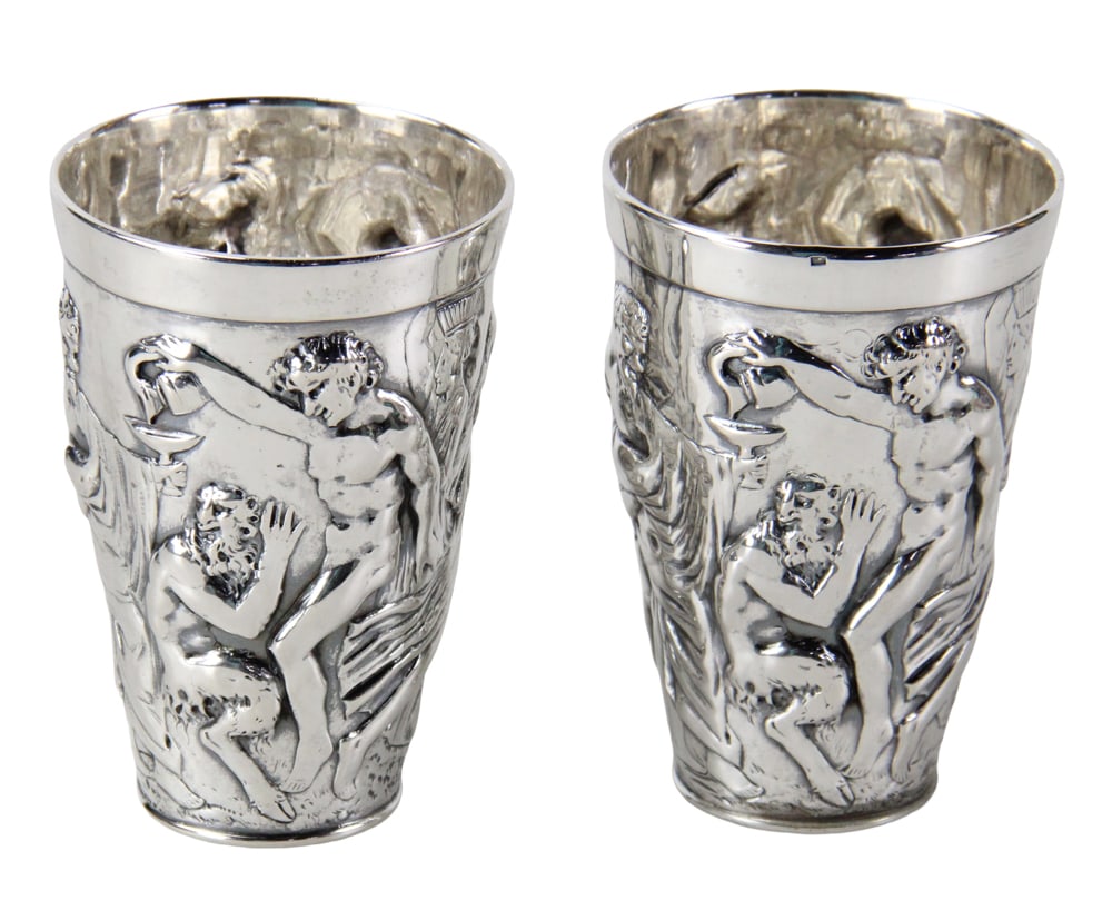 Pair of Repousse Silver Bacchanalia Wine Cups: Pair of repousse silver Bacchanalia wine cups, hallmarks unknown, possibly Hanau, test silver, but fineness not determined, 4 1/2" H x 3" diameter. Approximately 11.3 troy oz TW. Provenance: New York 