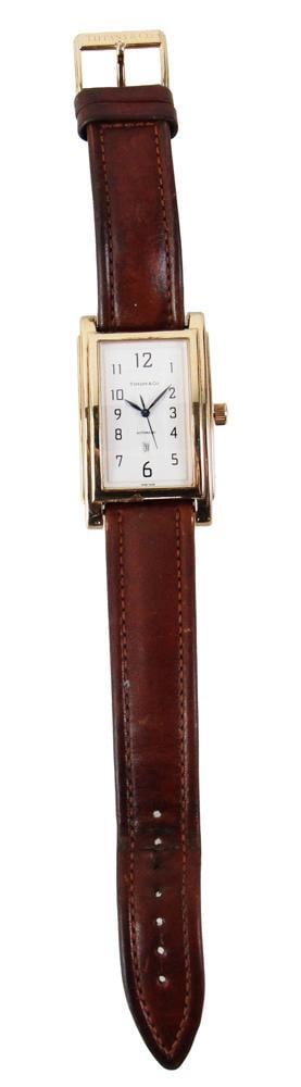 Tiffany and Co. 18k Yellow Gold Men's Watch: Tiffany and Co. 18k yellow gold men's wrist watch, automatic, engraved on reverse with owner's name, dates, etc., face 1 3/4" x 1". Approximately 93.7 grams TW (including buckle). Provenance: Haverhil