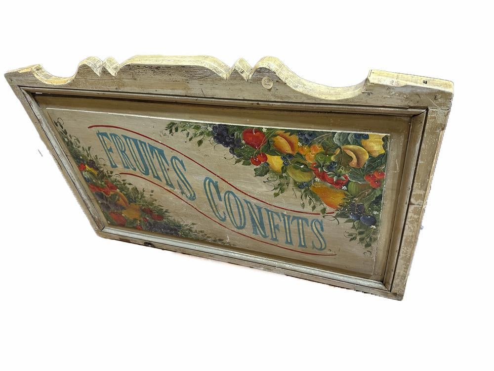French "Fruits Confits" Painted Sign: French "Fruits Confits" sign, hand-painted wood, signed "Fern Henry," circa early 20th century, 30" high x 47" wide. Provenance: from a Concord, Massachusetts estate.