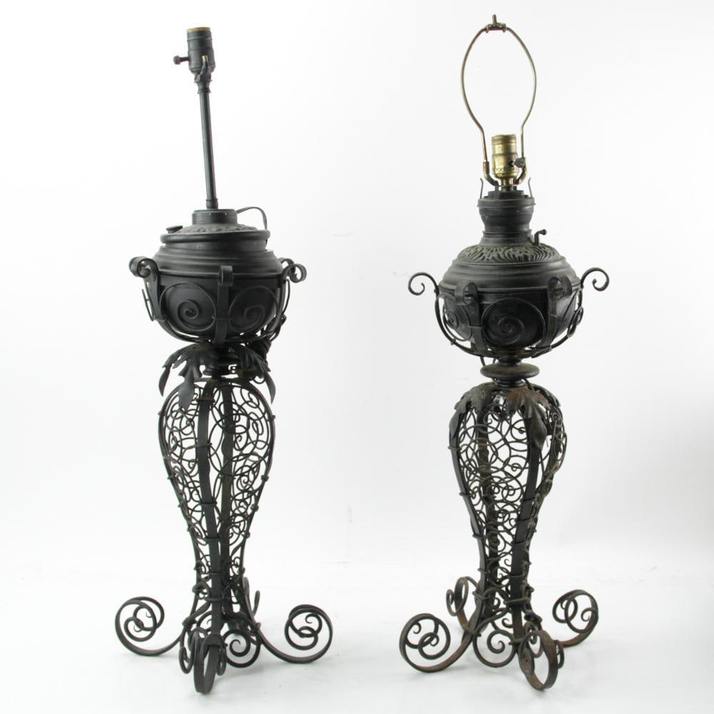 Old Wrought Iron Oil Lamps: Pair of old, wrought iron, electrified oil lamps, 34" H. Provenance: a Palm Beach, Florida estate.