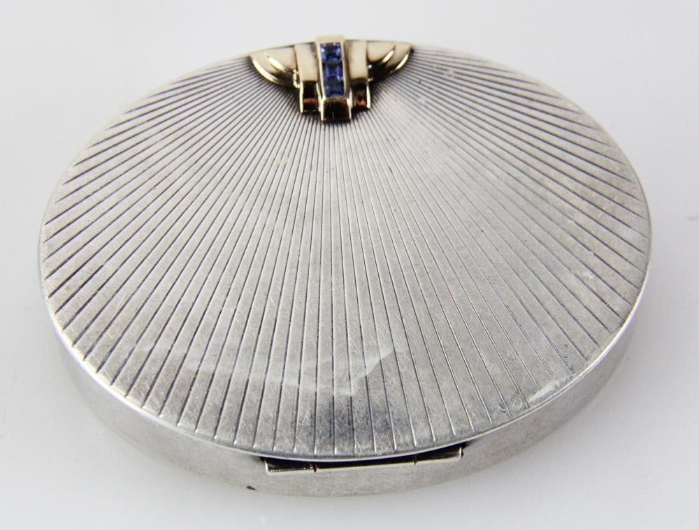 Tiffany and Co. Sterling and 14k Gold ??? with Sapphires: Tiffany and Co. sterling and 14k gold compact with seashell design and with sapphires. Approximately 2.1 troy oz TW. Provenance: New York City, New York collection. PLEASE NOTE: payment for silver, go