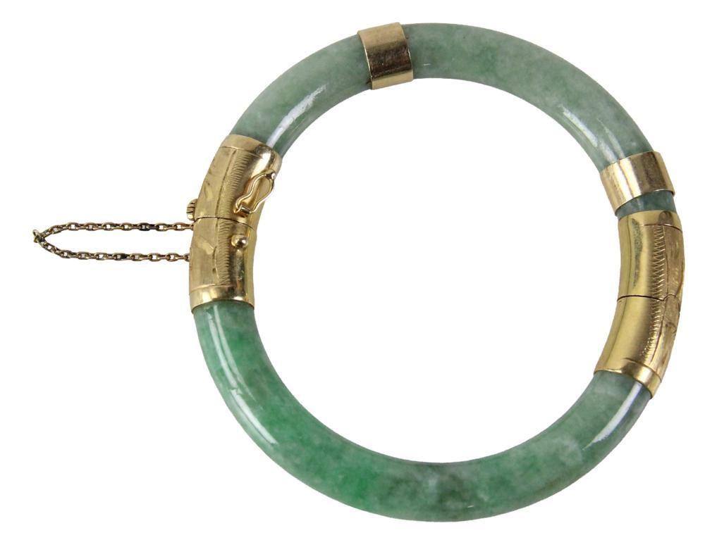 18k Yellow Gold and Green Jadeite Bracelet: 18k yellow gold and green jadeite bracelet, approximately 2 3/8" x 2 1/4" inside diameter. Provenance: New York estate. PLEASE NOTE: payment for silver, gold, jewelry, and coins must be made via wire 