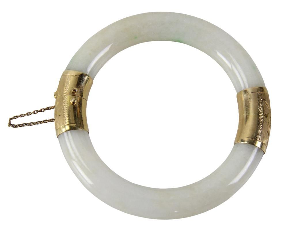 18k Yellow Gold and White Jadeite Bracelet: 18k yellow gold and white jadeite bracelet, approximately 2 3/8" x 2 1/4" inside diameter. Provenance: New York estate. PLEASE NOTE: payment for silver, gold, jewelry, and coins must be made via wire 