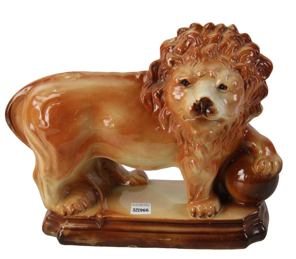 Staffordshire Brown-Glazed Standing Lion with Ball: Staffordshire standing lion with ball, brown glaze, stylized mane, 11" x 12". Provenance: Marblehead, Massachusetts collection.