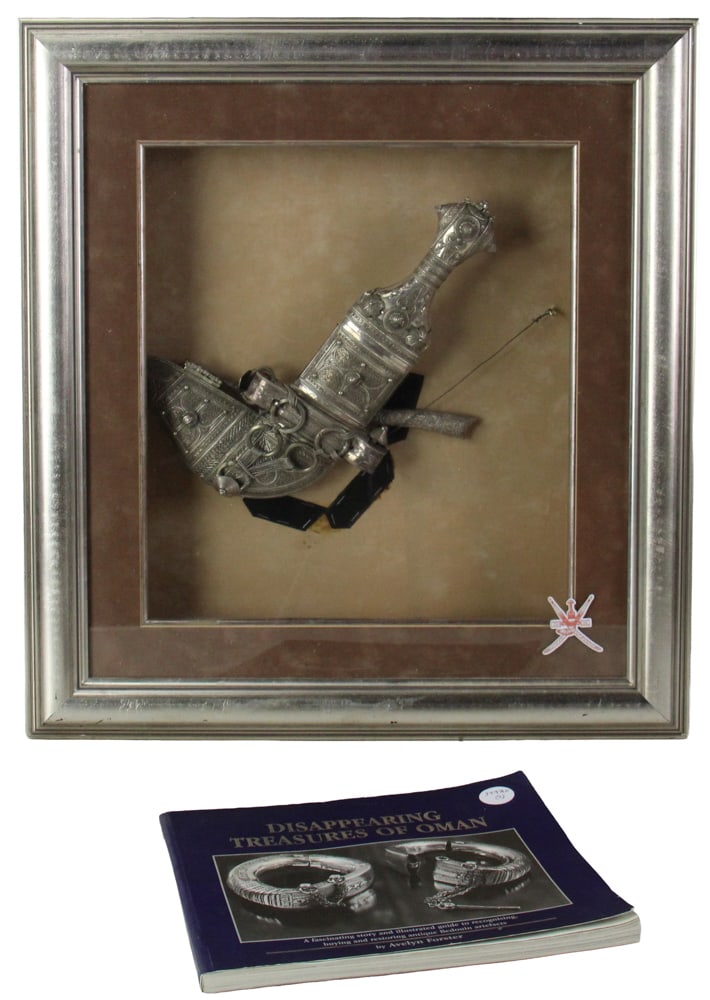 Omani Hand-Chased Silver Khanjar in Shadow Box Frame: Omani khanjar, silver, hand-chased, likely made for royalty, 11 1/2" x 6", in hand-designed shadow box frame 23" x 21 1/2". Not examined out of frame. Includes book "Disappearing Treasures of Oman". P