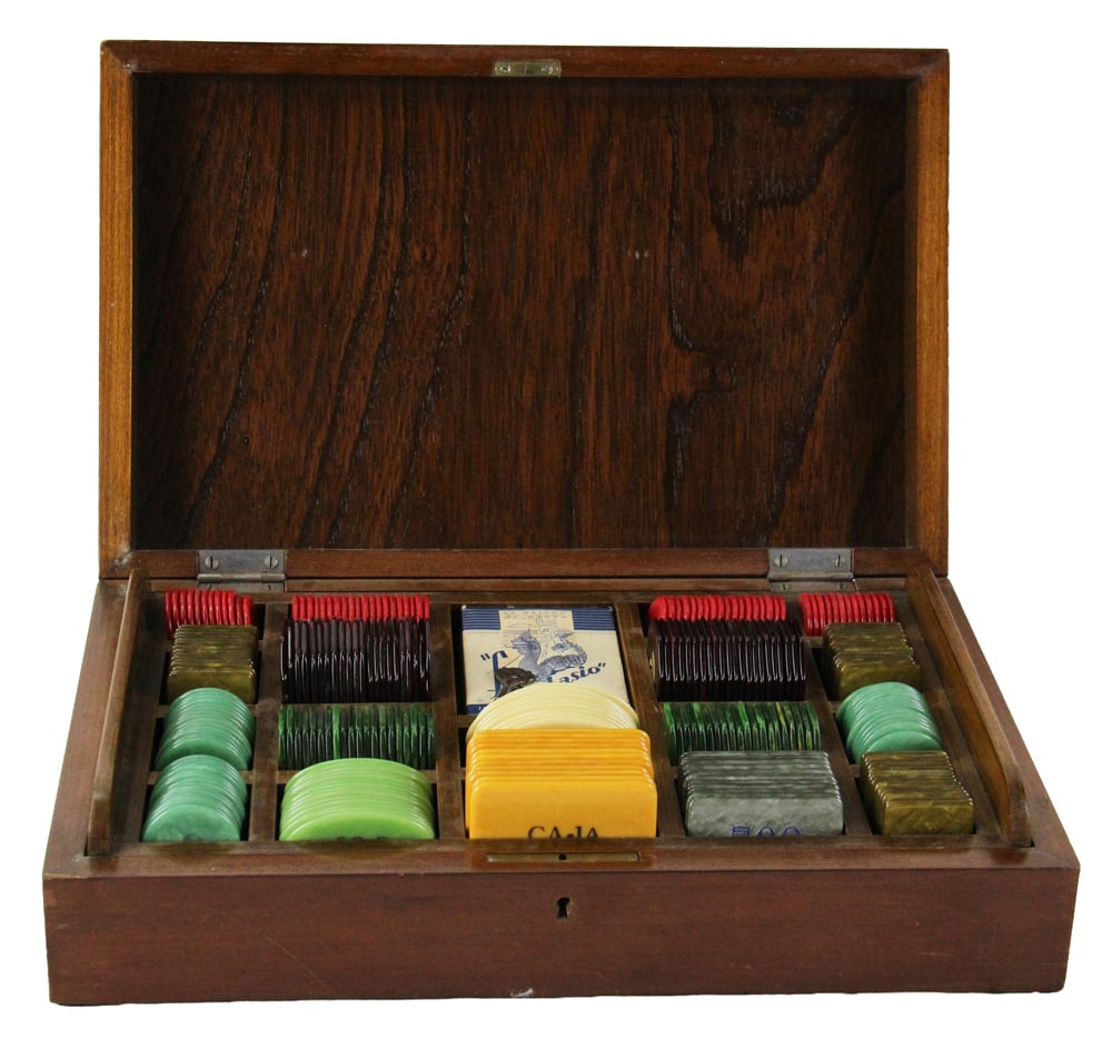 Set of Bakelite Gaming Chips and Deck of Cards: Set of Bakelite gaming chips and deck of cards. Chips have varying values on them. One set of chips have no value but marked CAJA. In original case, 3 1/2" H x 14 3/4" W x 9 1/2" D. 2 1/2" area of