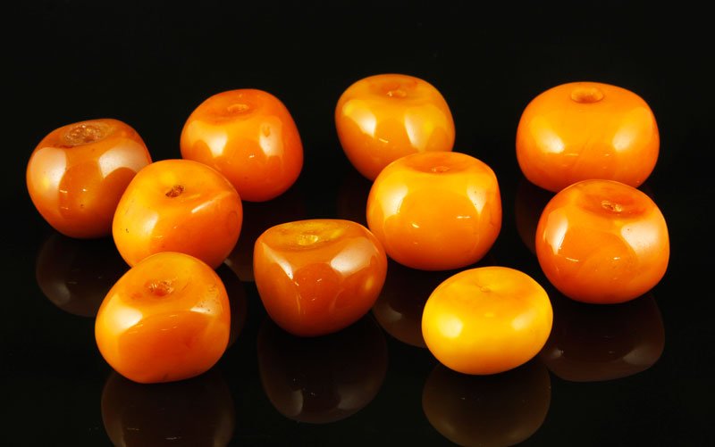 Lot of Ten Amber Beads: Lot of ten Amber beads, largest 1 1/2" x 7/8". Provenance: From a Howell, New Jersey collection.