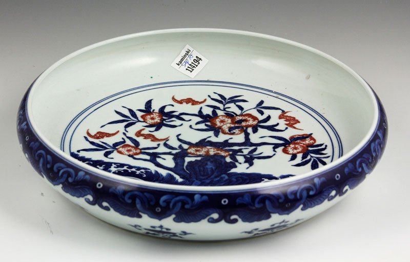 Chinese Blue and White Brush Washer: Blue and white porcelain brush washer, China, round and shallow with a red glazed peach tree and bats, 12" dia.