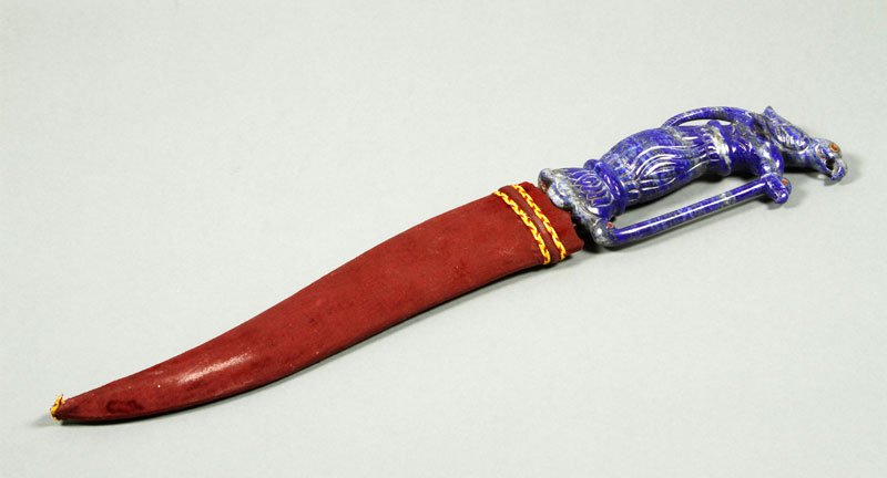 Mughal Dagger with Lapis and Jeweled Grip: Mughal dagger with carved lapis and jeweled grip, blade is lightly engraved all over and inlaid with gold near the grip, 17 1/4” l, blade only 10 3/4” l, with unmatching possibly later sheath.