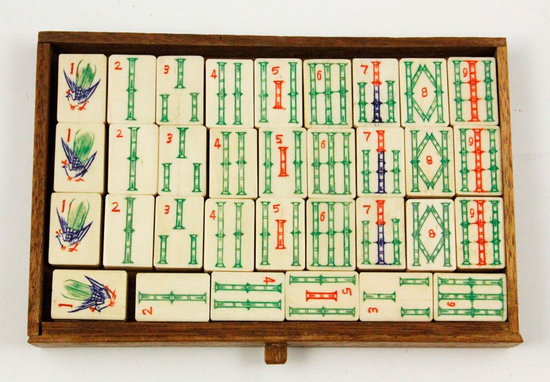 Chinese 19th C. Mah Jong Set: Mah Jong set, China, 19th century, with finely carved figures and handle, five drawer interior with elephant bone pieces, 8 1/4” x 9 1/2” w x 6 3/4” d.