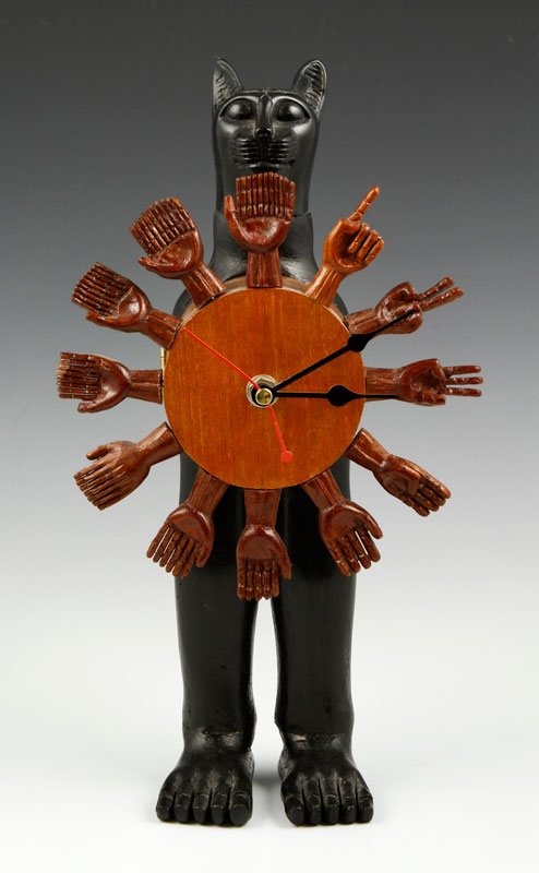 Friedeberg Egyptian Cat Clock: Pedro Friedeberg, Egyptian cat clock, ebonized wood and carved wood assemblage with head made of composite mahogany, signed on right side of clock face in marker "Pedro Friedeberg", circa 1970s, 12" x